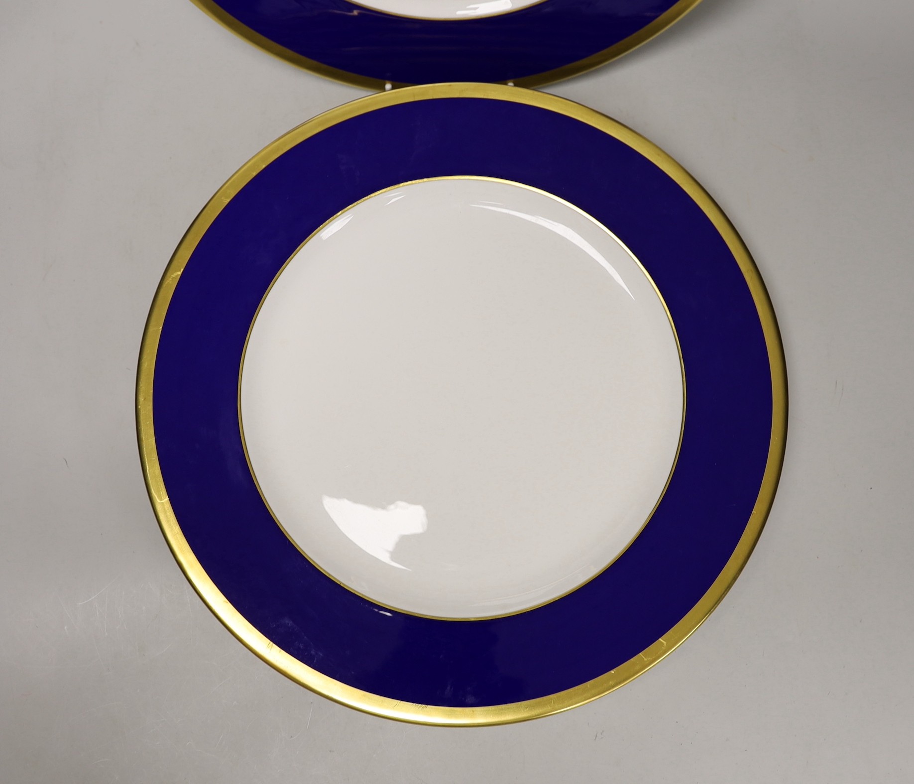 Six Asprey, London, blue and gilt banded dinner plates, 34cms diameter